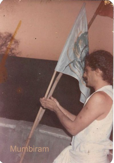 First-Peacock-feather-flag, Mumbiram First Peacock feather flag being hoisted atop the corner of Mumbiram´s atelier