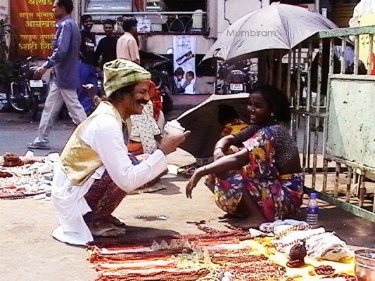 Mumbiram at Babitas shop, Mumbiram Mumbiram could pass as a Phase Pardhi dressed in his colourful exotic attire chatting up dark beauty Babita
